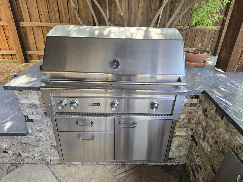Lynx built-in grill with stainless cabinets before cleaning and polishing, showing water spots and haze