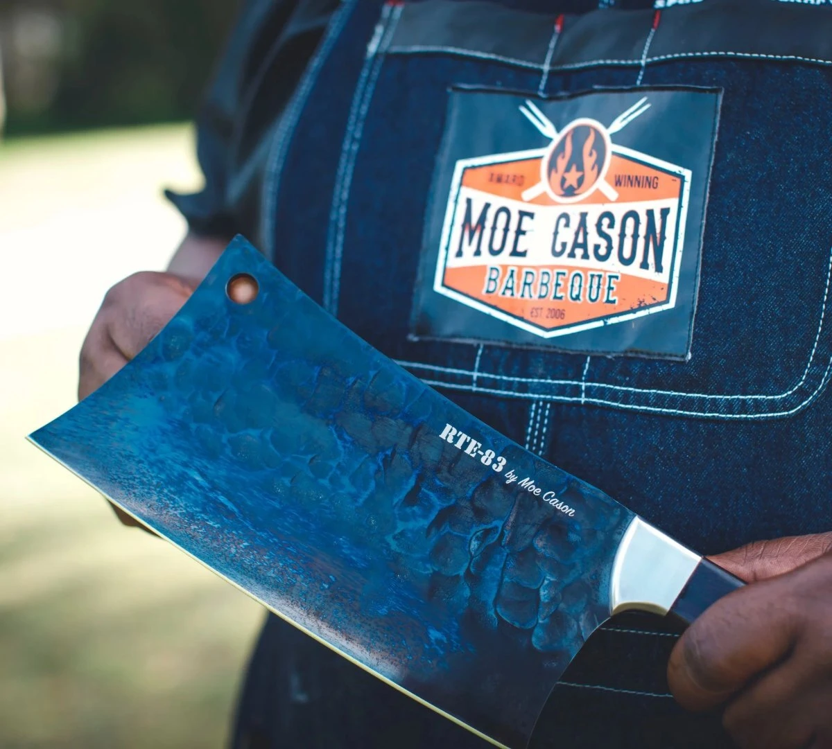 Close-up of the hammered black titanium-coated blade on the Moe Cason Meat Cleaver, engraved RTE-83 by Moe Cason