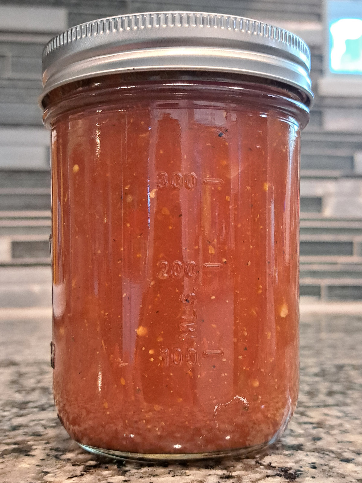 Jar of Small Batch TX Scotch Bonnet Salsa on a granite counter