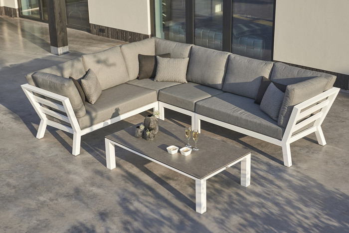 Timber outdoor corner lounge set with high arm in white powder-coated aluminium frame. Cushions in picture are similar in look to actual cushions supplied by Poynters. But our cushions have been upgraded to premium Sunbrella Fabric in Natte grey.
There is also available, a single arm-less sofa to make the corner sofa longer, and arm chairs and 2.5 person sofa in the range. The coffee table displayed in the picture is NOT included or available. We have Leaf tables available.
