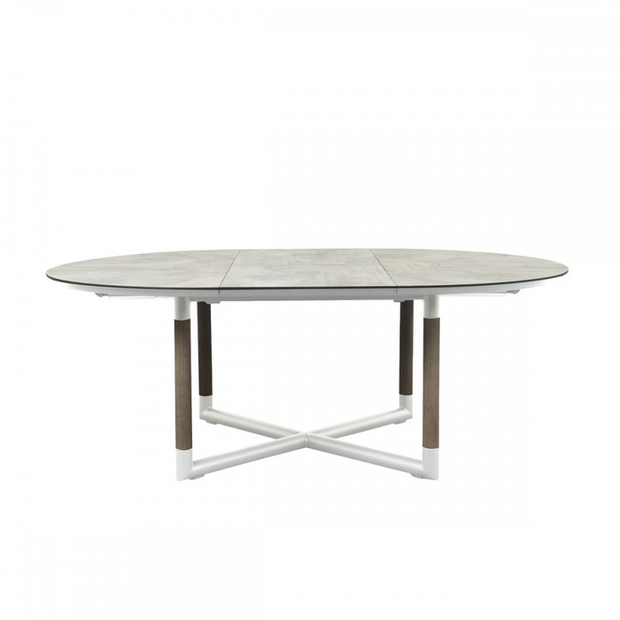 BASTINGAGE outdoor round extension table with HPL (high pressure laminate) top and aluminium frame, with teak accent legs. Shown in extended size from 146x206cm