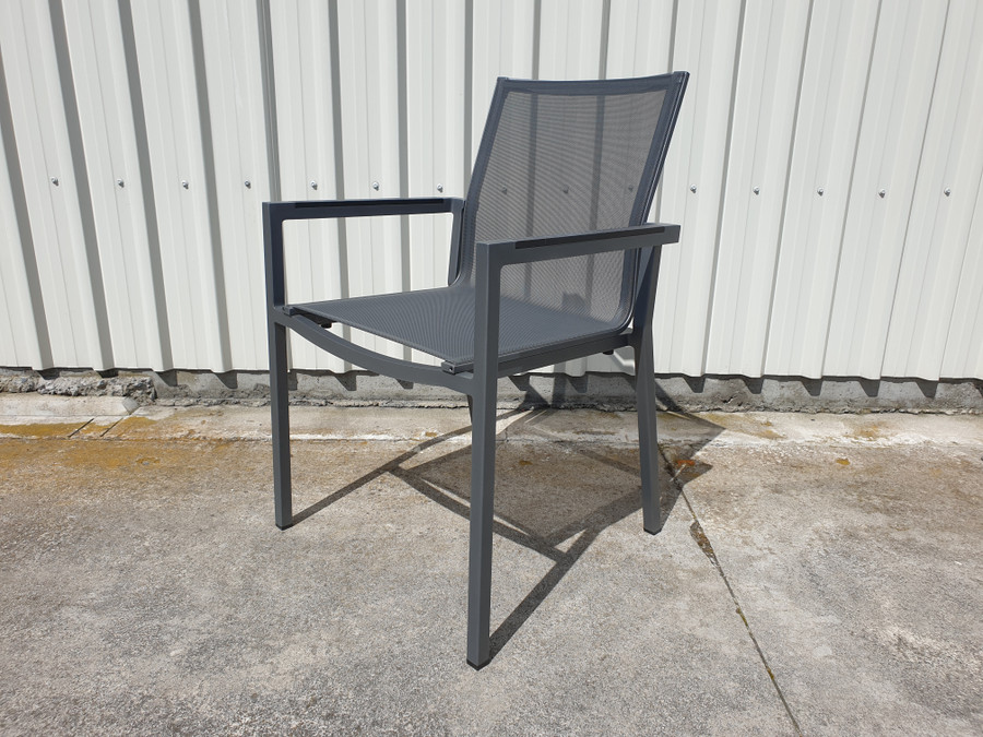 View of AMAKA dining arm chair in slate grey, with High Pressure Laminate armrests