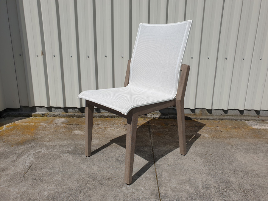 COPENHAGUE outdoor dining  side chair by Les Jardins. Teak wood frame is finished in a Duratek coating with premium White Batyline Eden sling seat - angled view