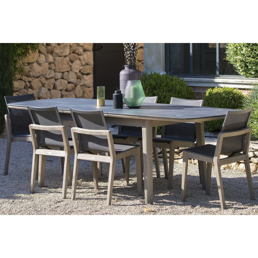 In situ picture of COPENHAGUE outdoor table with faux slate grey top - extended from 2m-2.8m with matching COPENHAGUE dining side chairs.