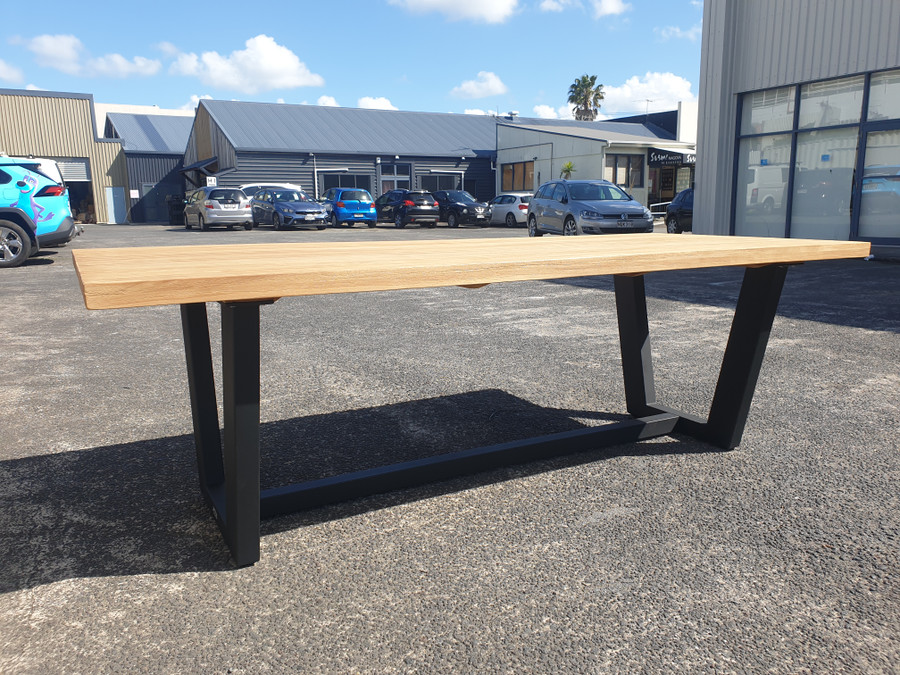 Joe outdoor teak table with lava coloured powder-coated aluminium legs.