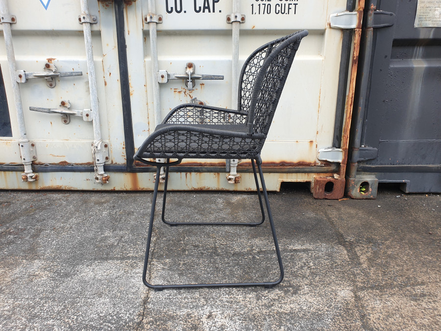 Side view of Celine outdoor dining arm chair in lava, with canvas black squab.