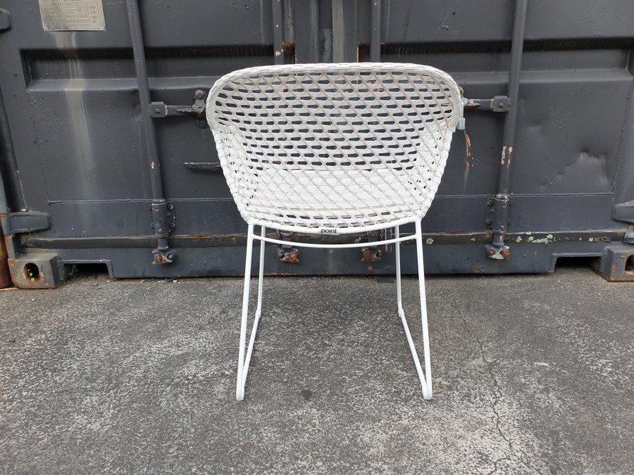 Rear view of Iris Outdoor Dining Arm Chair with  2 tone chalk white and pale beige interlaced wicker and canvas sand squab