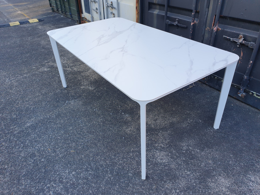 Angled view of FARO cast aluminium and ceramic top outdoor table - white frame with ceramic faux carrara marble top