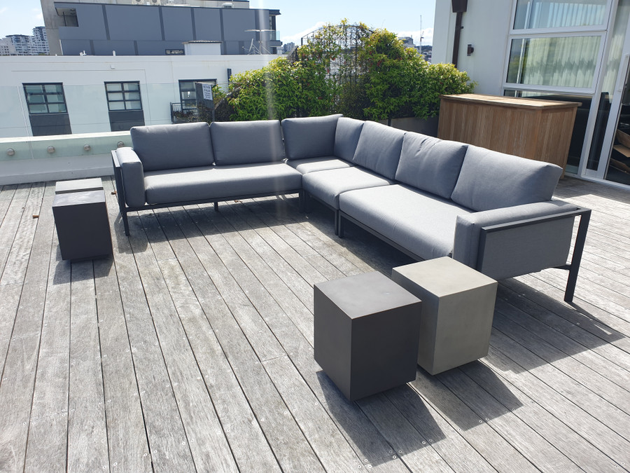 Reef outdoor corner sofa set located  on rooftop patio of apartment tower. Picture also shows optional extra single sofa piece which are available separately.
NOW ONLY AVAILABLE WITH WHITE FRAME AND NATTE GREY CUSHIONS AS ILLUSTRATED! CHARCOAL FRAME SOLD OUT!