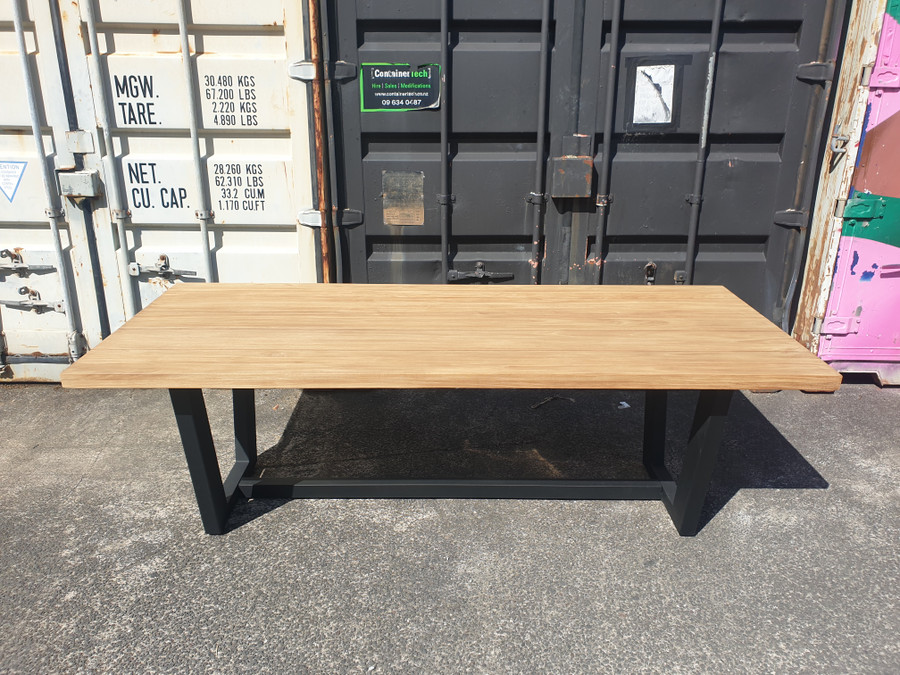Side view of Joe teak and aluminiun outdoor table with tapered legs