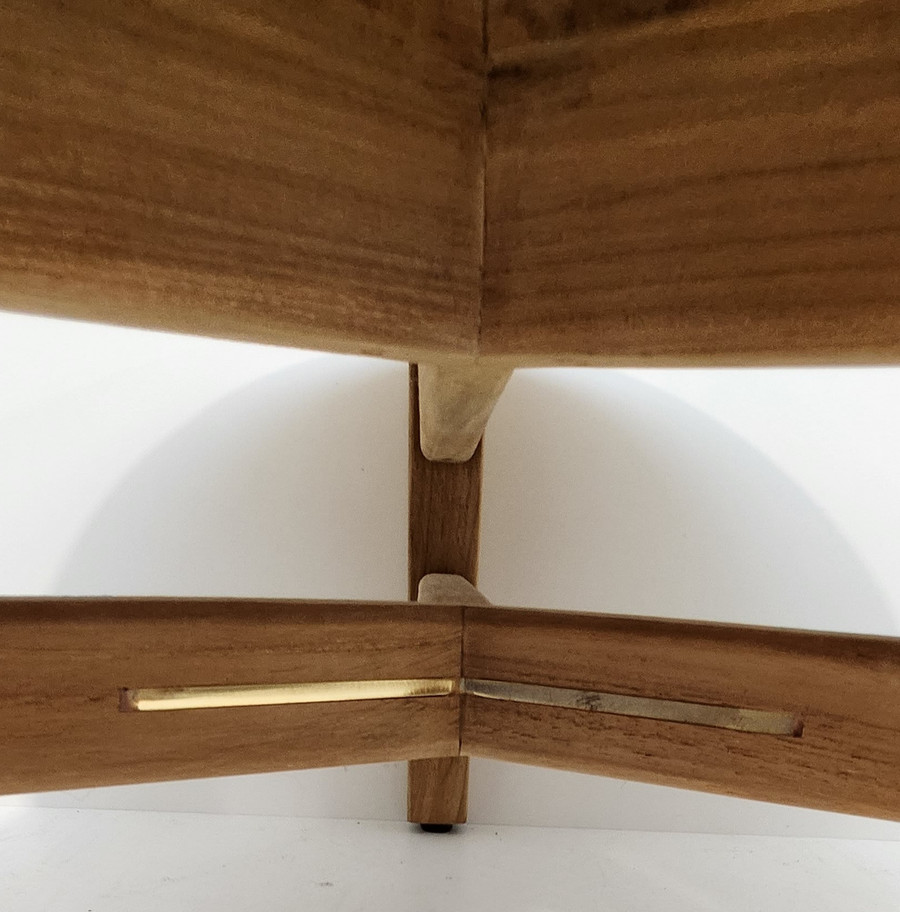 Brass inserts on the teak coffee table legs