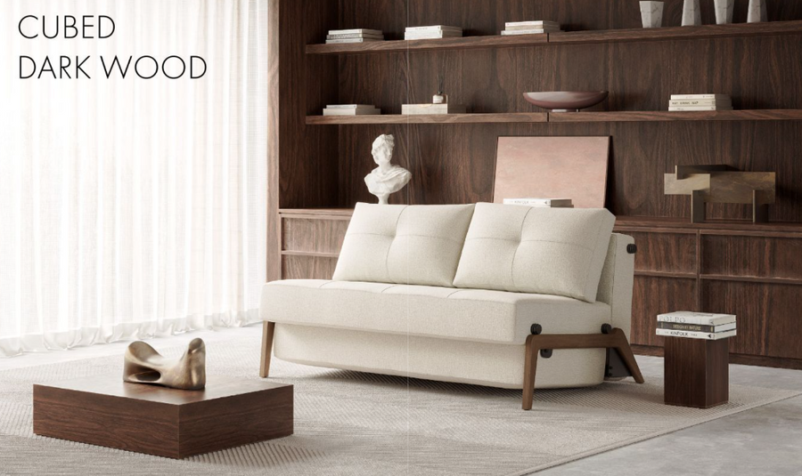CUBED 160 sofa bed shown in modern light coloured fabric and contrasting dark oak wood legs