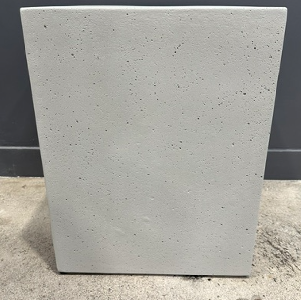 Lime lightweight concrete stool, has intentional  'bugholes' on surface, to create interest and an intentional aesthetic feature.