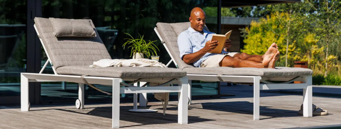 Delta High Version 45cm high including Sunbrella Cushion, shown with beige cushion, the Delta sunlounger with white frame is supplied with Sunbrella cushions and head rest in Sunbrella Natte Grey Chine (light grey)