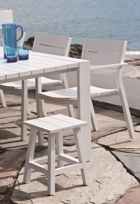 MESSINA outdoor stool/side table displayed here in White at the end of a dining table (WHITE SOLD OUT!)