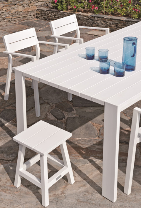 MESSINA outdoor stool/side table displayed here in White at the end of a dining table (WHITE SOLD OUT!)