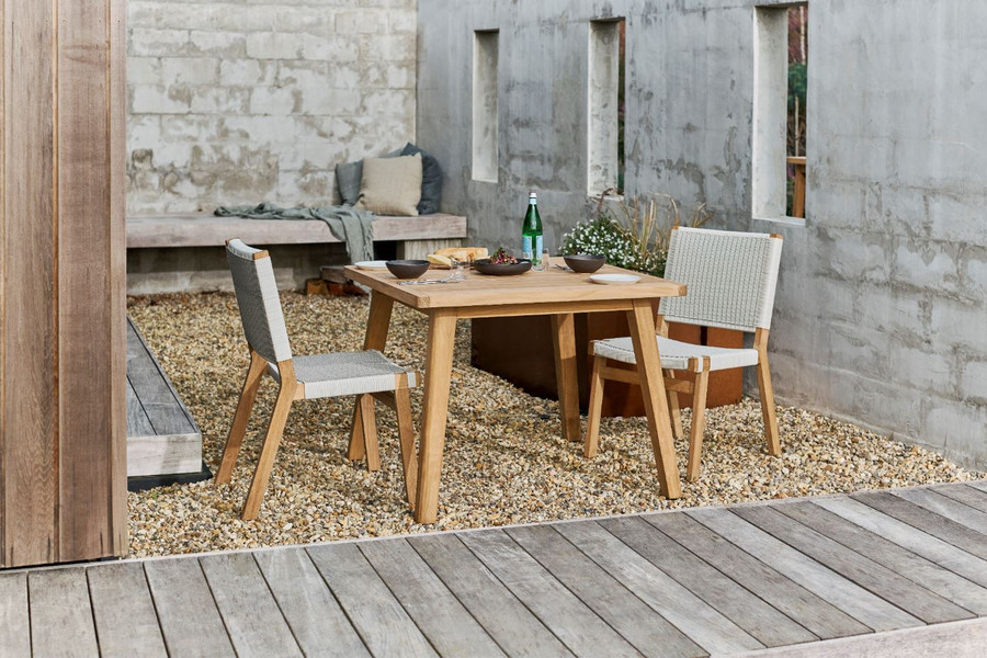 Devon Jackson outdoor teak dining side chairs in whitewash shown with matching Porter outdoor square teak table.