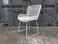 Angle view of Celine outdoor dining arm chair in stone grey, with canvas smoke squab.