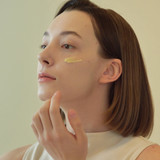 Gently applying Beauty of Joseon eye serum to reduce puffiness and dark circles