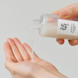 Milky texture of Beauty of Joseon Rice Milk toner being poured on hand