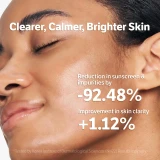 Model rinsing face with water after using kojic acid gel cleanser