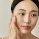 Model applying Beauty of Joseon Light On Serum for a radiant and even skin tone