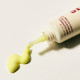 Cream texture on fingertip, showing rich yet lightweight finish ideal for the delicate under‑eye area.