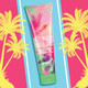 Bath and Body Works Vacay Vibes fragrance lotion displayed against a vibrant yellow and pink tropical palm tree background.