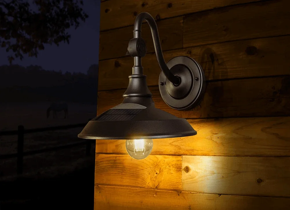 Vintage solar LED barn light glowing on a wooden wall at night