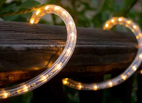 Warm white LED rope light wrapped on a wooden hand rail