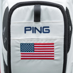 PING Pioneer ball pocket: white bag with PING logo and American flag embroidered on the pocket.