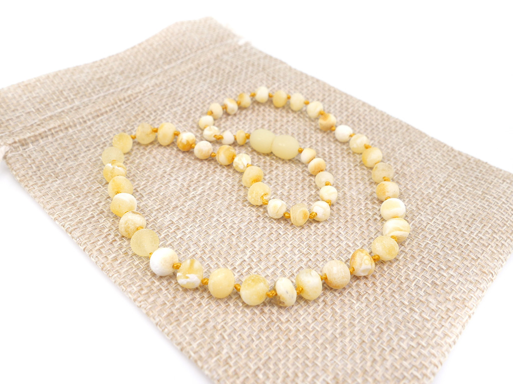 Unpolished milky white Baltic amber teething necklace in butterscotch tones with handcrafted baroque beads