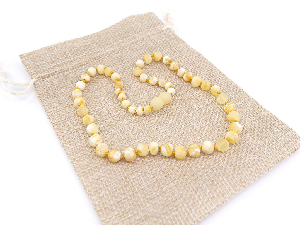 Rare butterscotch white Baltic amber teething necklace featuring unpolished baroque stones
