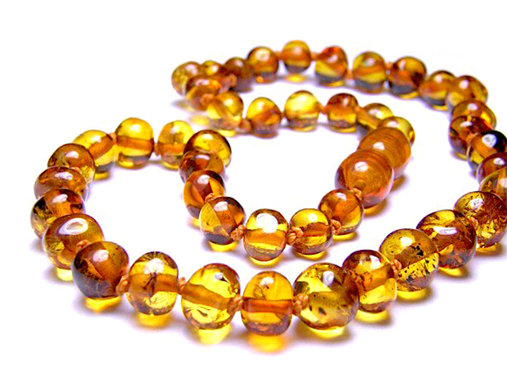 Lightweight children’s amber necklace in transparent cognac colour with knotted bead design - traditional teething style design