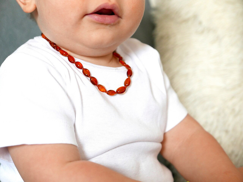 Polished cognac amber teething necklace featuring smooth rounded Baltic beads 