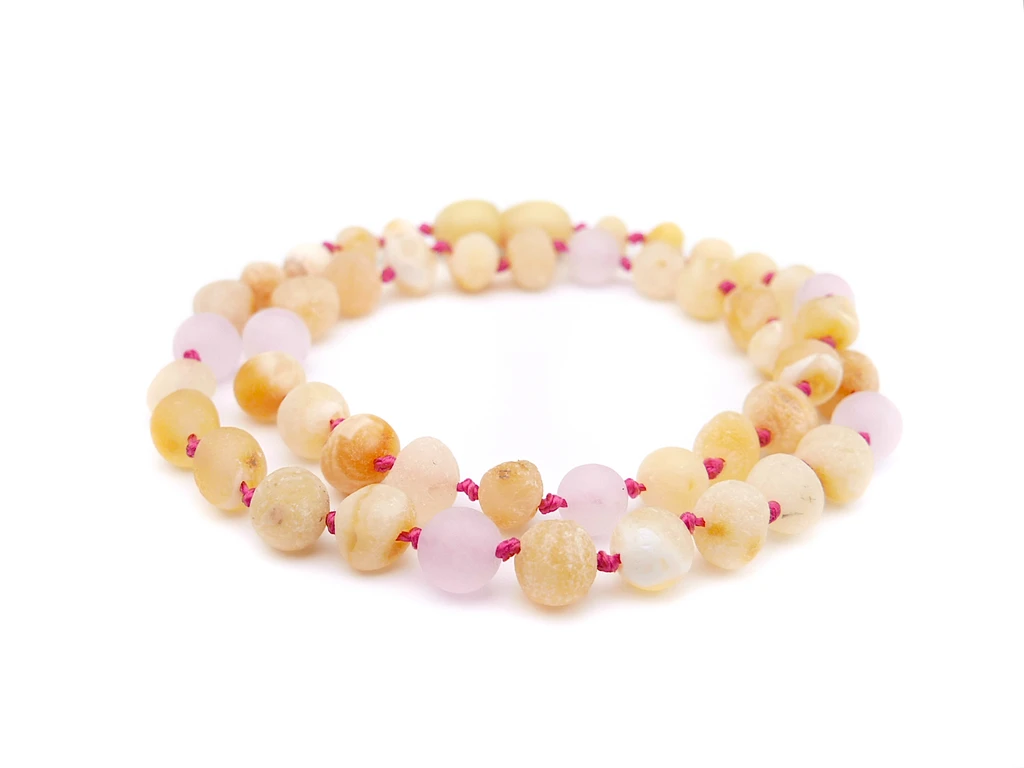 Raw-style Baltic amber teething necklace with earthy butterscotch nuggets and soft matte rose quartz for children