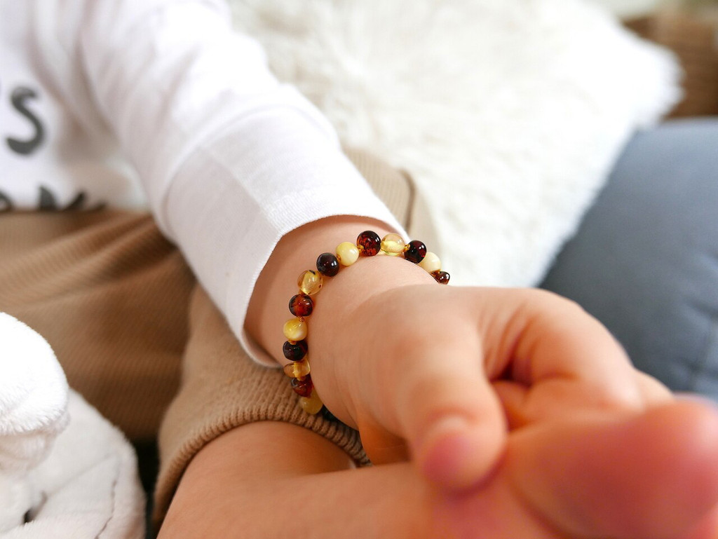 Multi coloured amber teething bracelet for boys and girls. 