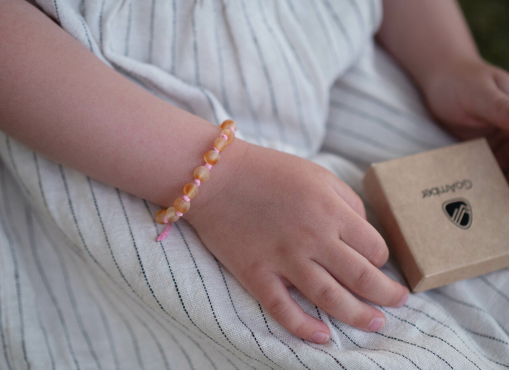 Raw unpolished multicoloured Baltic amber teething anklet with pink cord handmade in the Baltic region 