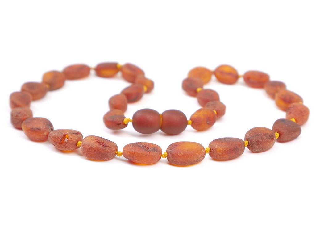 Children’s amber jewellery piece with earthy raw cognac olive-shaped beads
