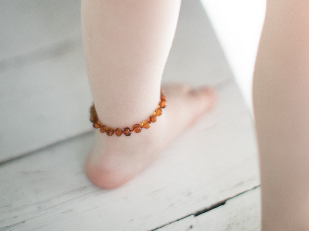 Baby cognac amber teething bracelet crafted from genuine Baltic amber with polished baroque bead design