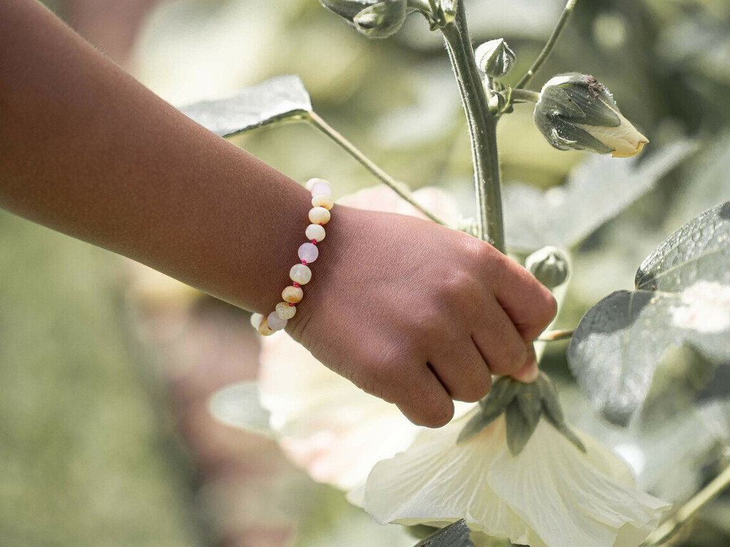 Butterscotch raw amber teething bracelet with soft pink rose quartz gemstones handmade in the Baltic region