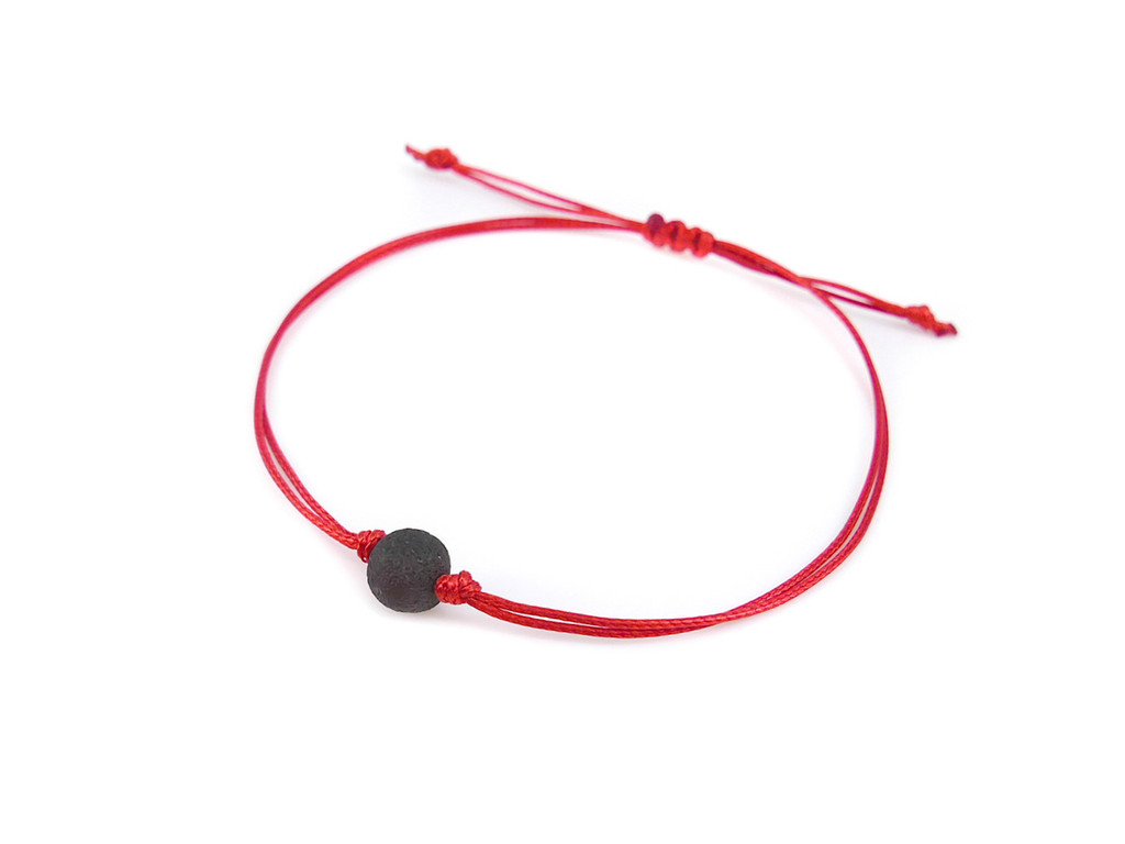 Red string bracelet with amber