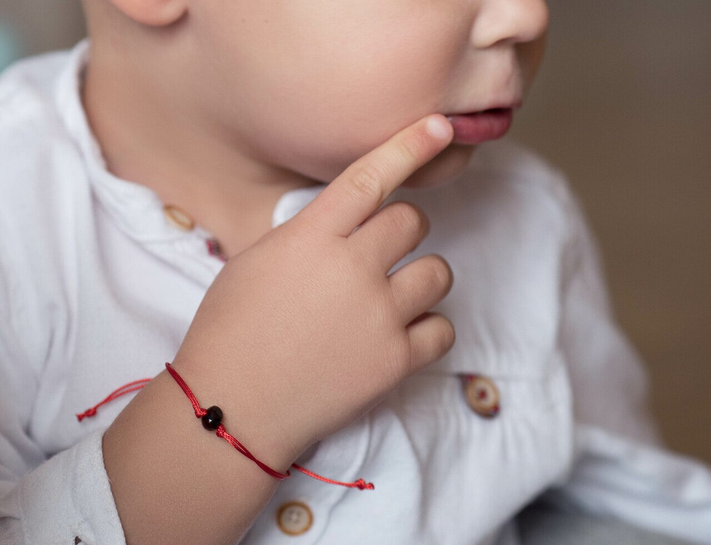 Kids Red String Kabbalah Bracelet with dark cherry polished amber