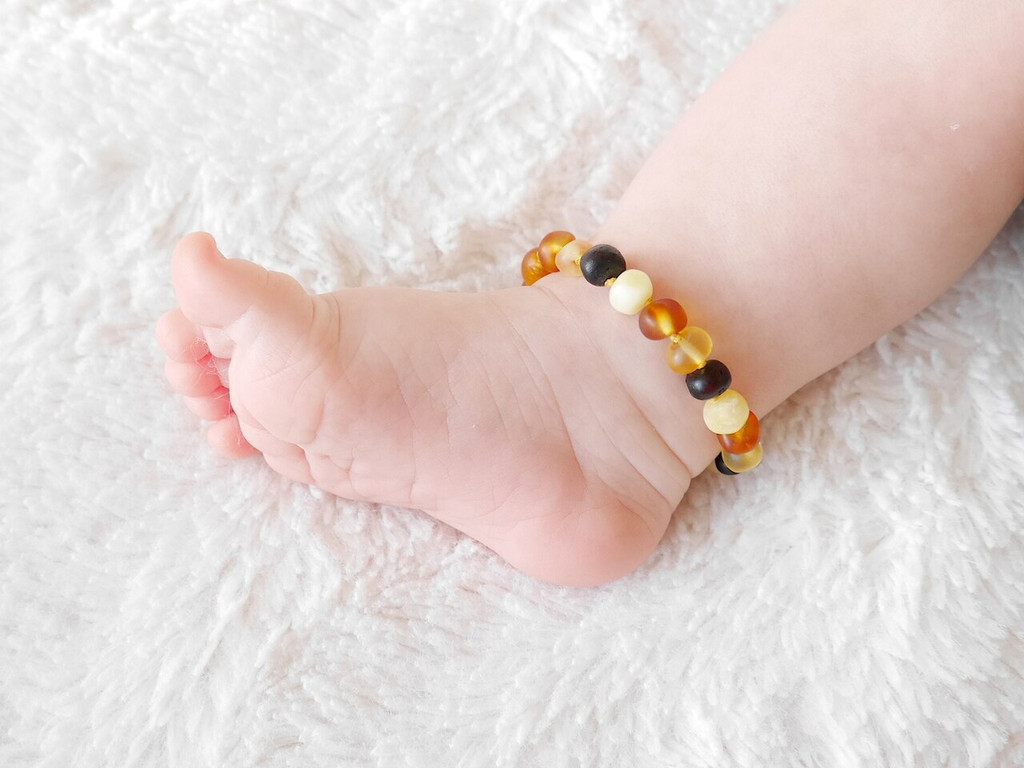 Raw unpolished multicoloured Baltic amber teething anklet for kids handcrafted from genuine amber beads with earthy tones 