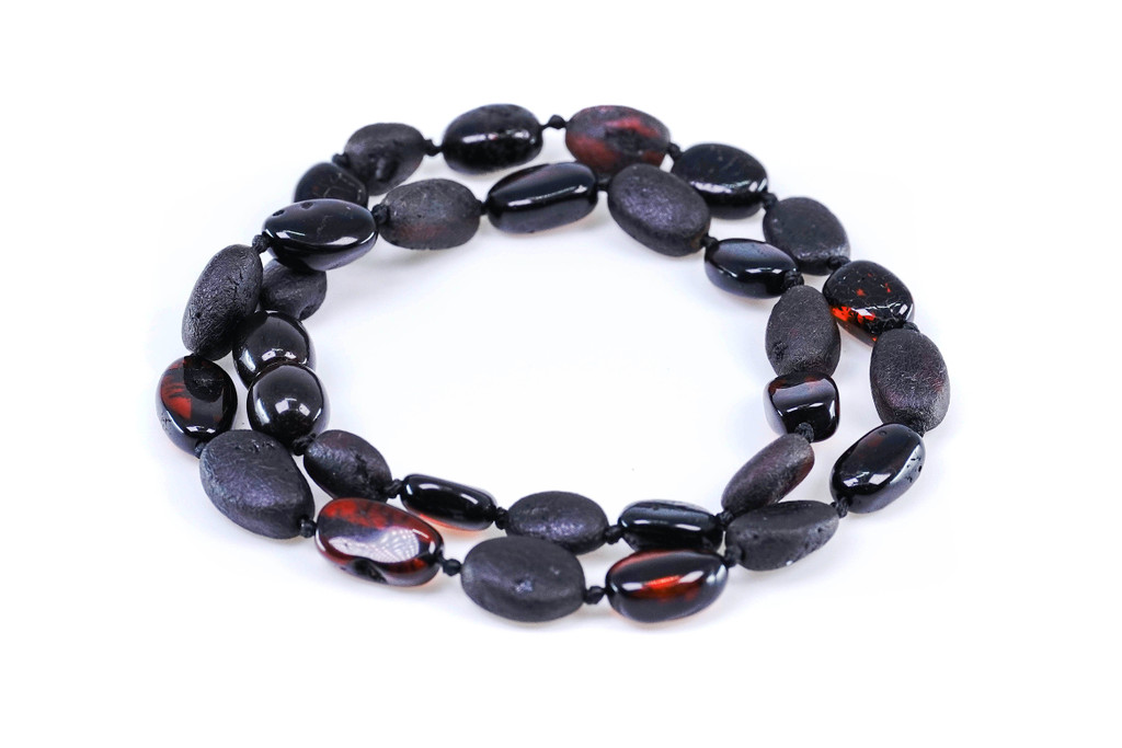 Children’s Baltic amber teething necklace crafted with natural dark cherry and black raw oval beads