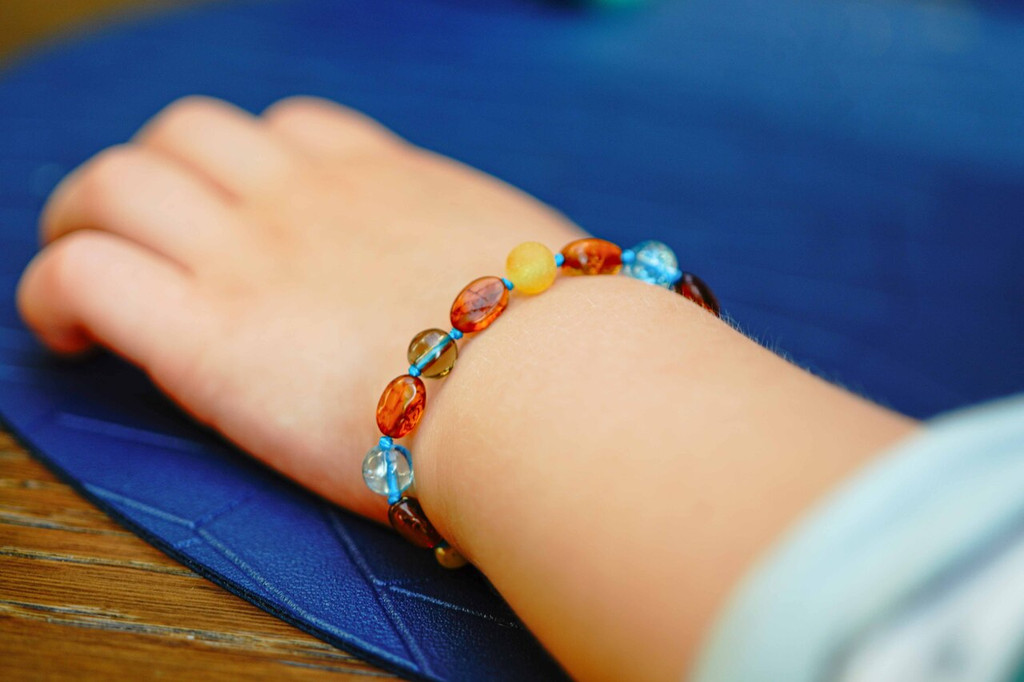 Raw Baltic amber teething bracelet featuring smoky quartz and blue quartz accents handcrafted children’s anklet with secure screw clasp