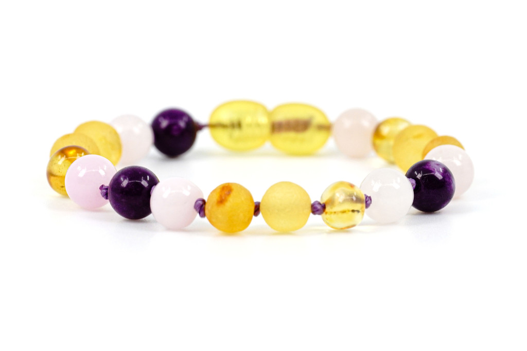 Amber teething bracelet or anklet featuring raw and polished baroque beads with Pink Rose Quartz and Dark Purple Chalcedony gemstones 