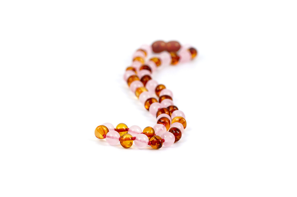 Handmade Baltic amber necklace featuring smooth polished beads and feminine rose quartz - traditional teething style design