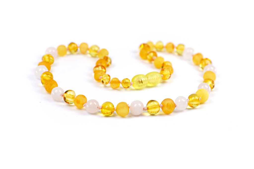 Eco-friendly Baltic amber teething necklace with mixed bead textures and gentle pink rose quartz stones 