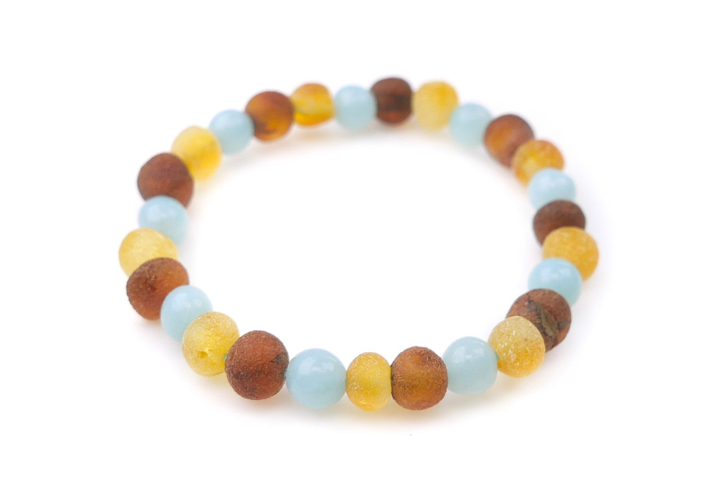 Small handmade Baltic amber anklet with blue aquamarine gemstones and elastic cord, designed in newborn size